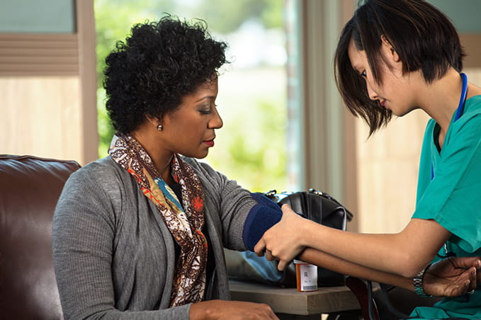 woman taking blood pressure on another woman