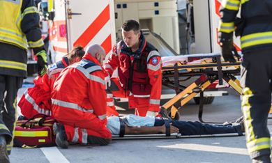 EMT paramedics helping man on stretcher