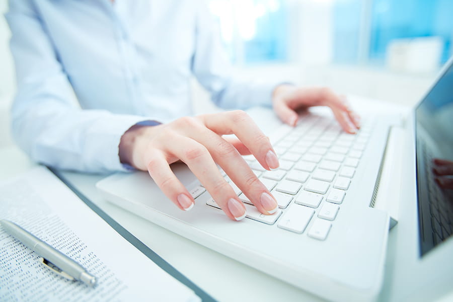 hands on keyboard using laptop
