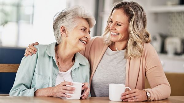older mother and adult daughter conversation over coffee older mother and adult daughter conversation over coffee