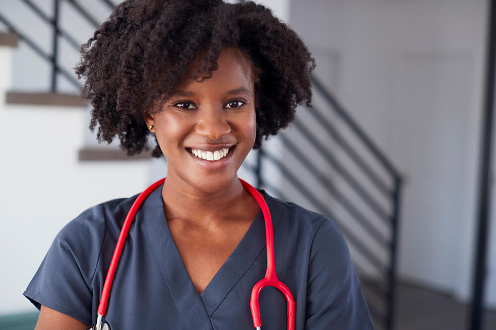 smiling female nurse wearing scrubs