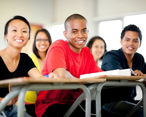 high school students sitting at desks in classroom