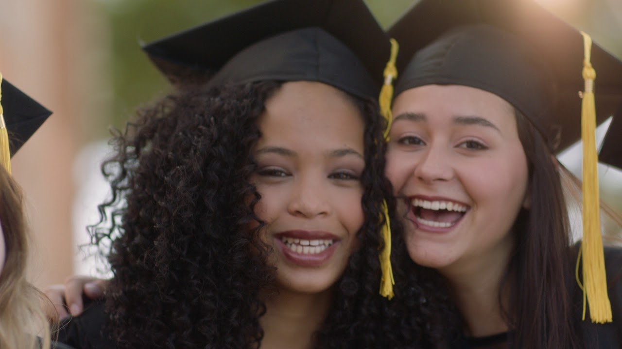 shared moments two female students in cap and gown