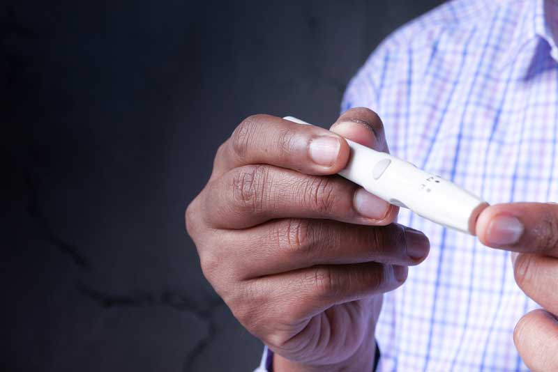 man checking his blood sugar