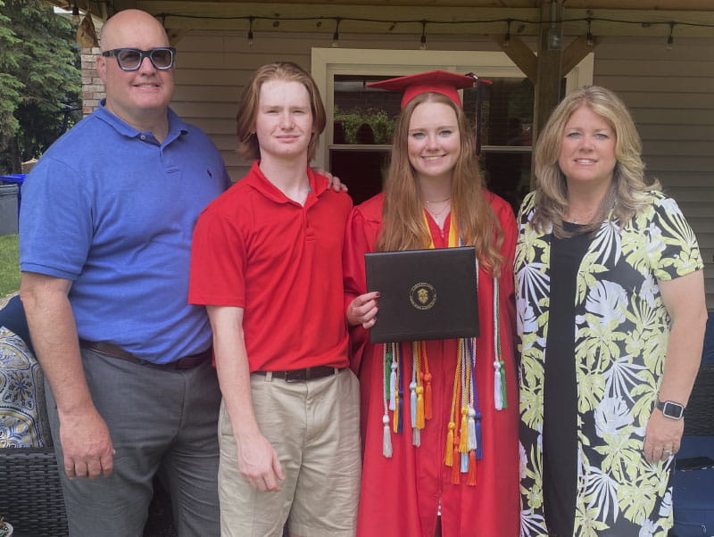 Maddy Ferriter with her parents and brother at her high school graduation. From left: John, Evan, Maddy and Kim. (Photo courtesy of the Ferriter family)