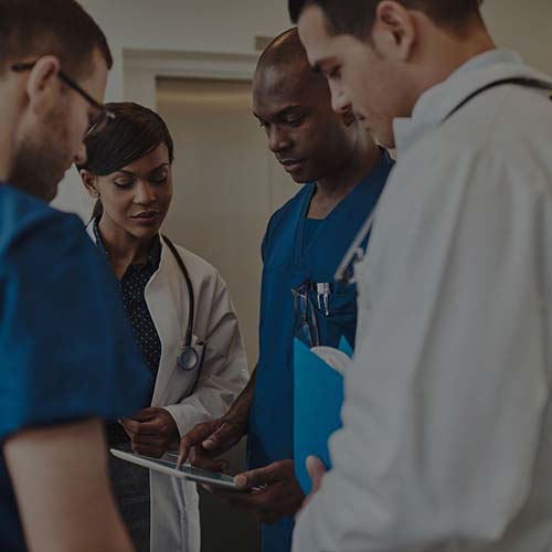 medical workers looking at tablet
