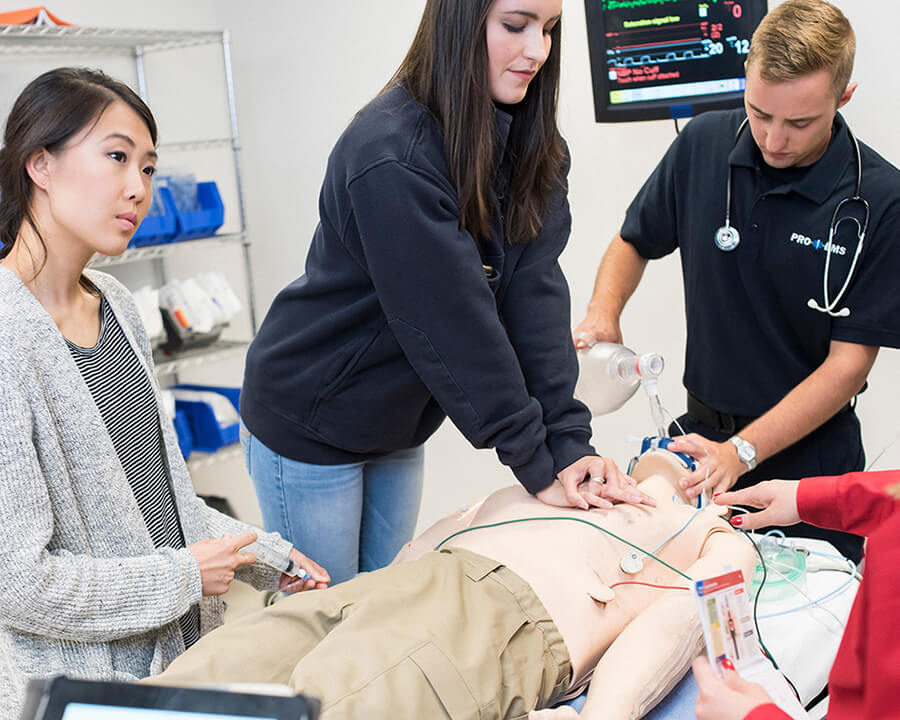 young adults learning CPR on manikin