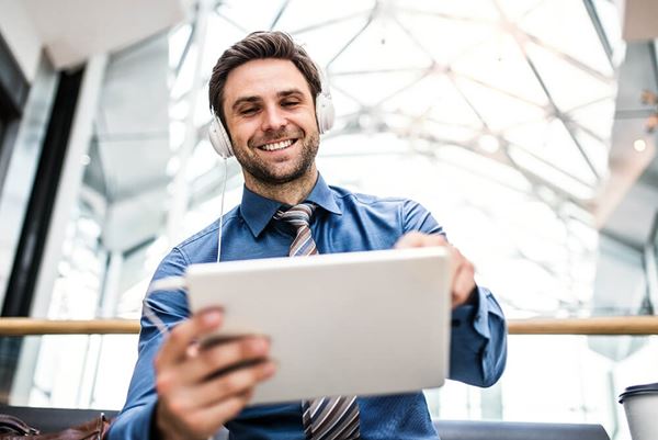 businessman with tablet and headphones in office businessman_with_tablet_and_headphones_in_office