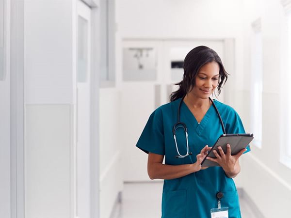 Top image Nurse holding tablet min image Top image Nurse holding tablet min image