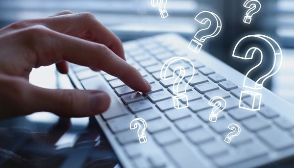 floating question marks over a keyboard illustrating FAQs floating question marks over a keyboard illustrating FAQs image